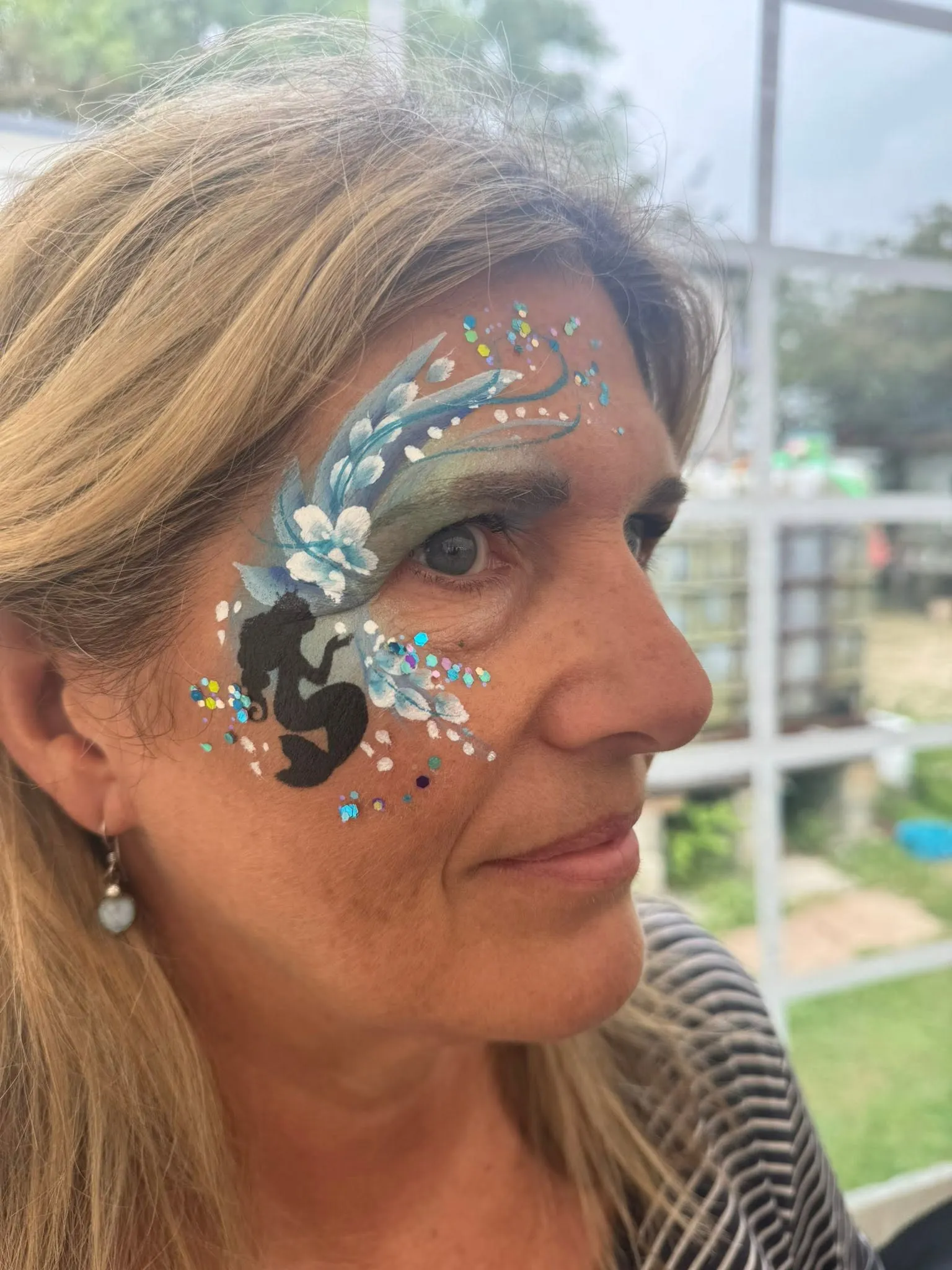 Woman with a dark blue swirl eye design