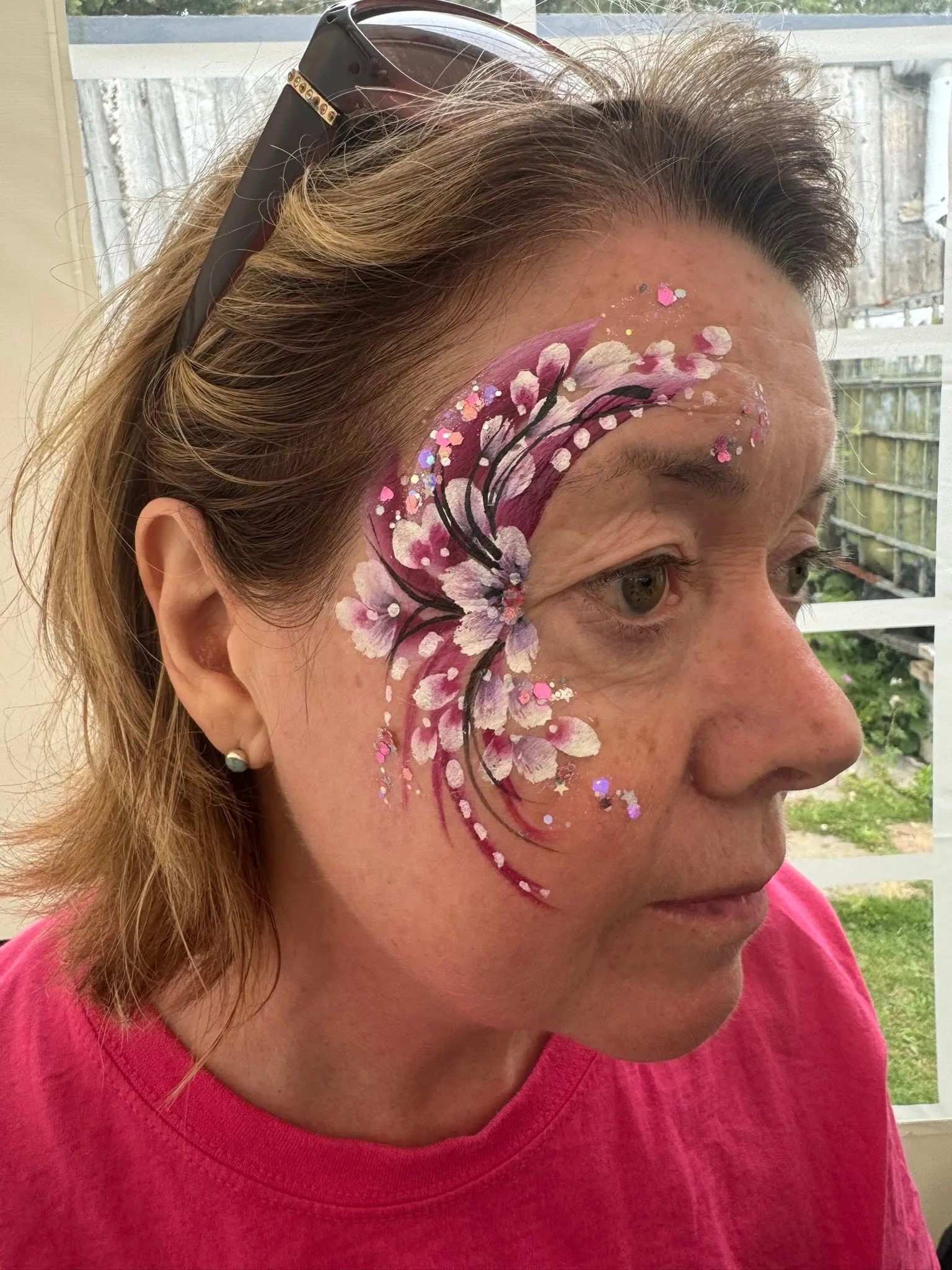 Woman with a pink gem and dot swirl design