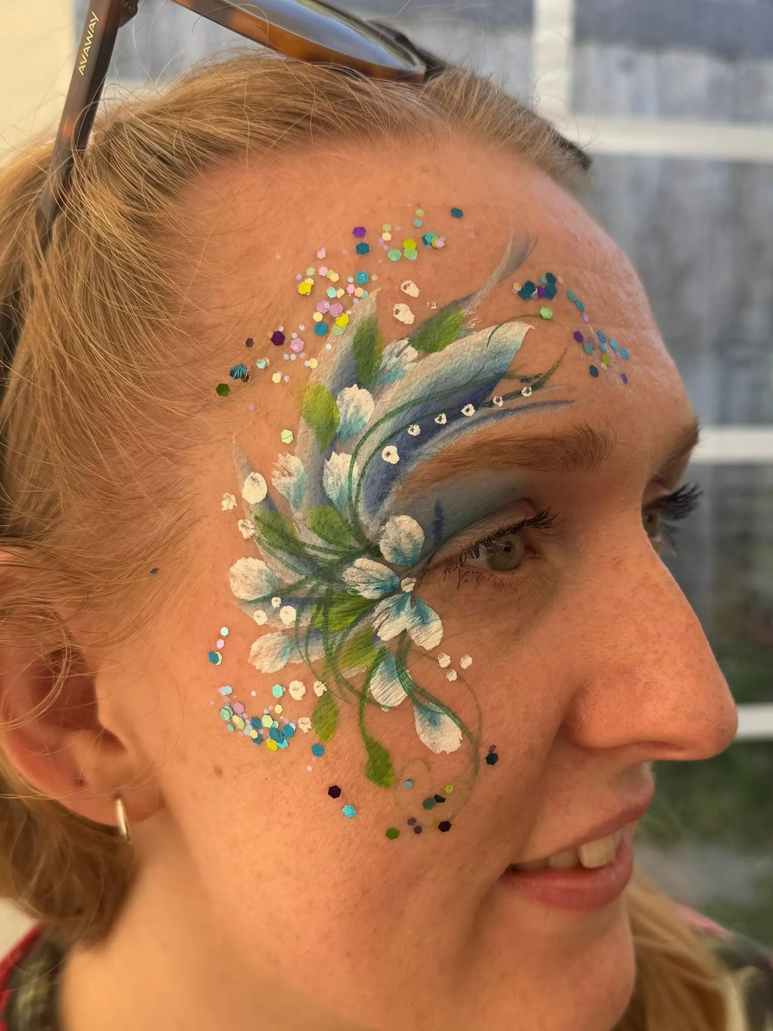 Woman with a green gem and flower eye design