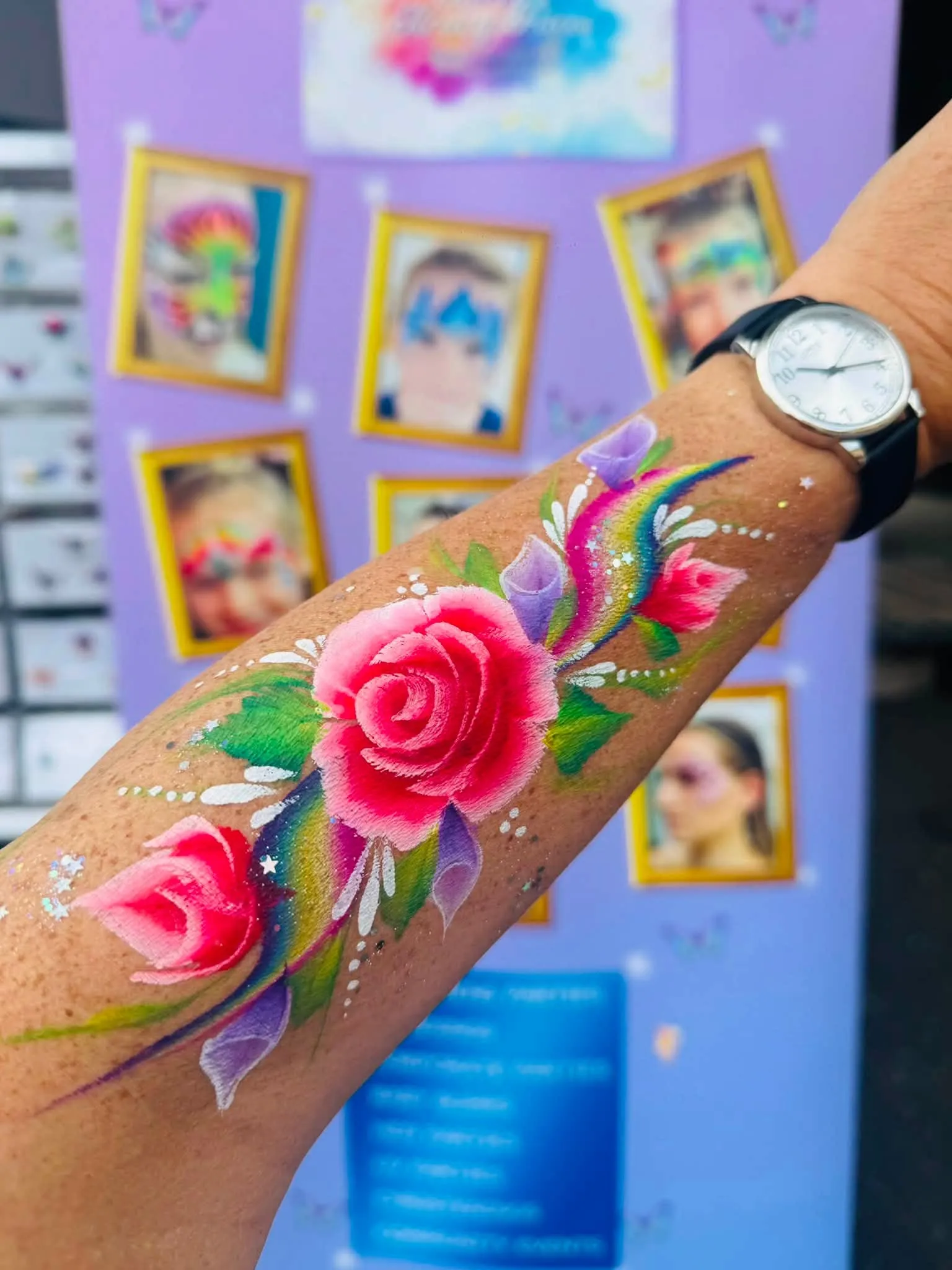 Painted pink rose on a forearm