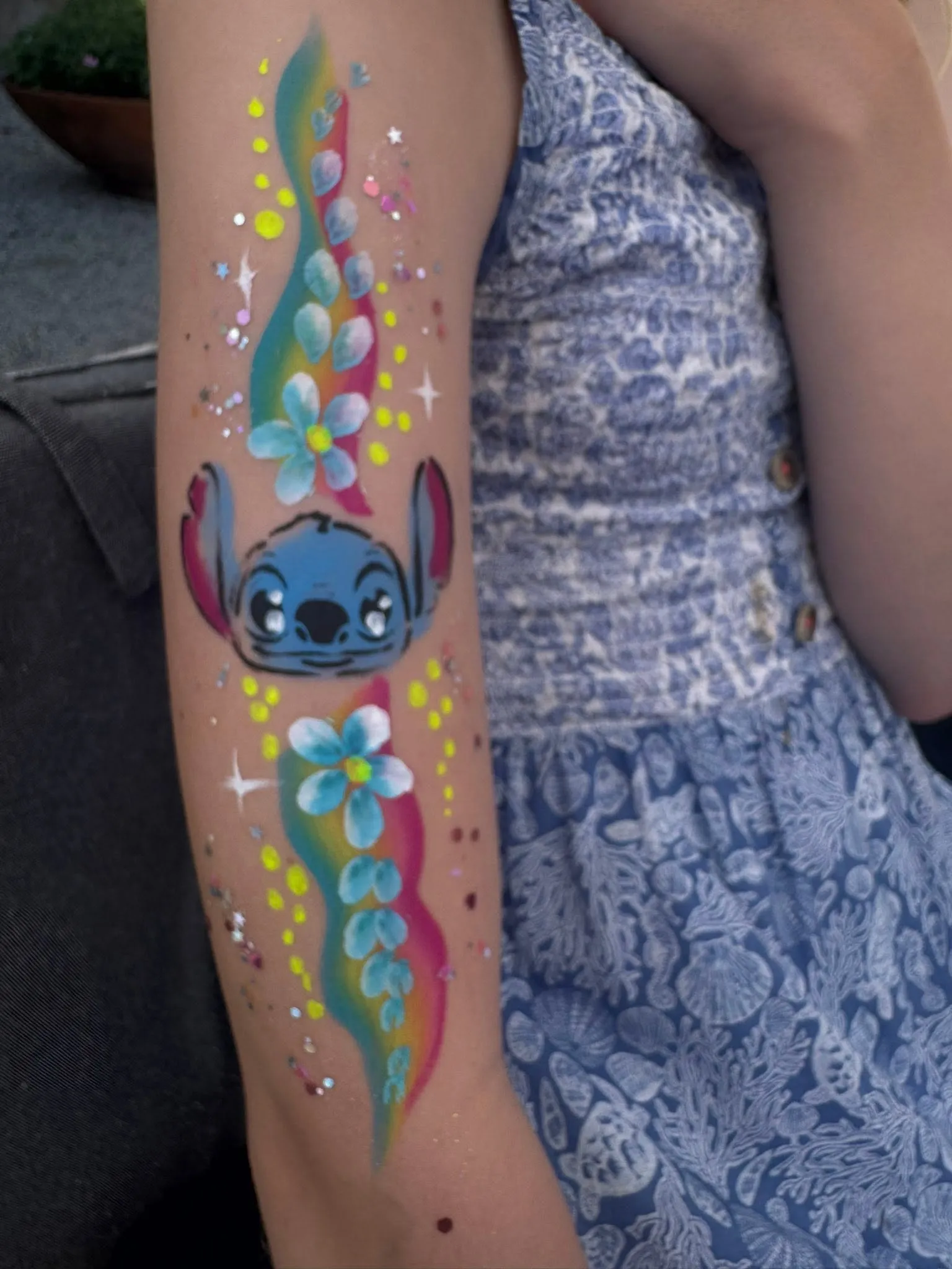 Painted cartoon character on an arm