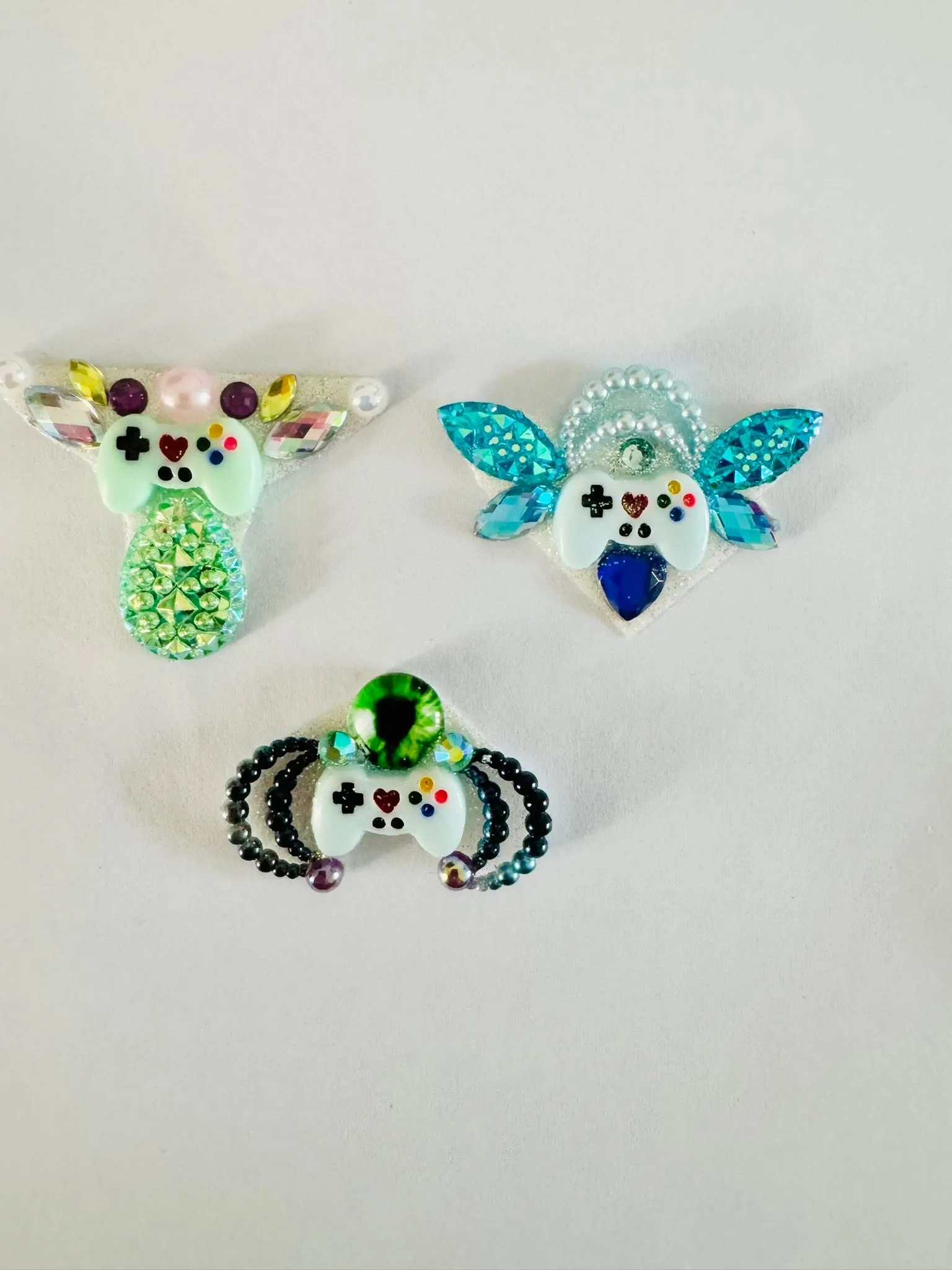 Handmade bee and flower gems on white