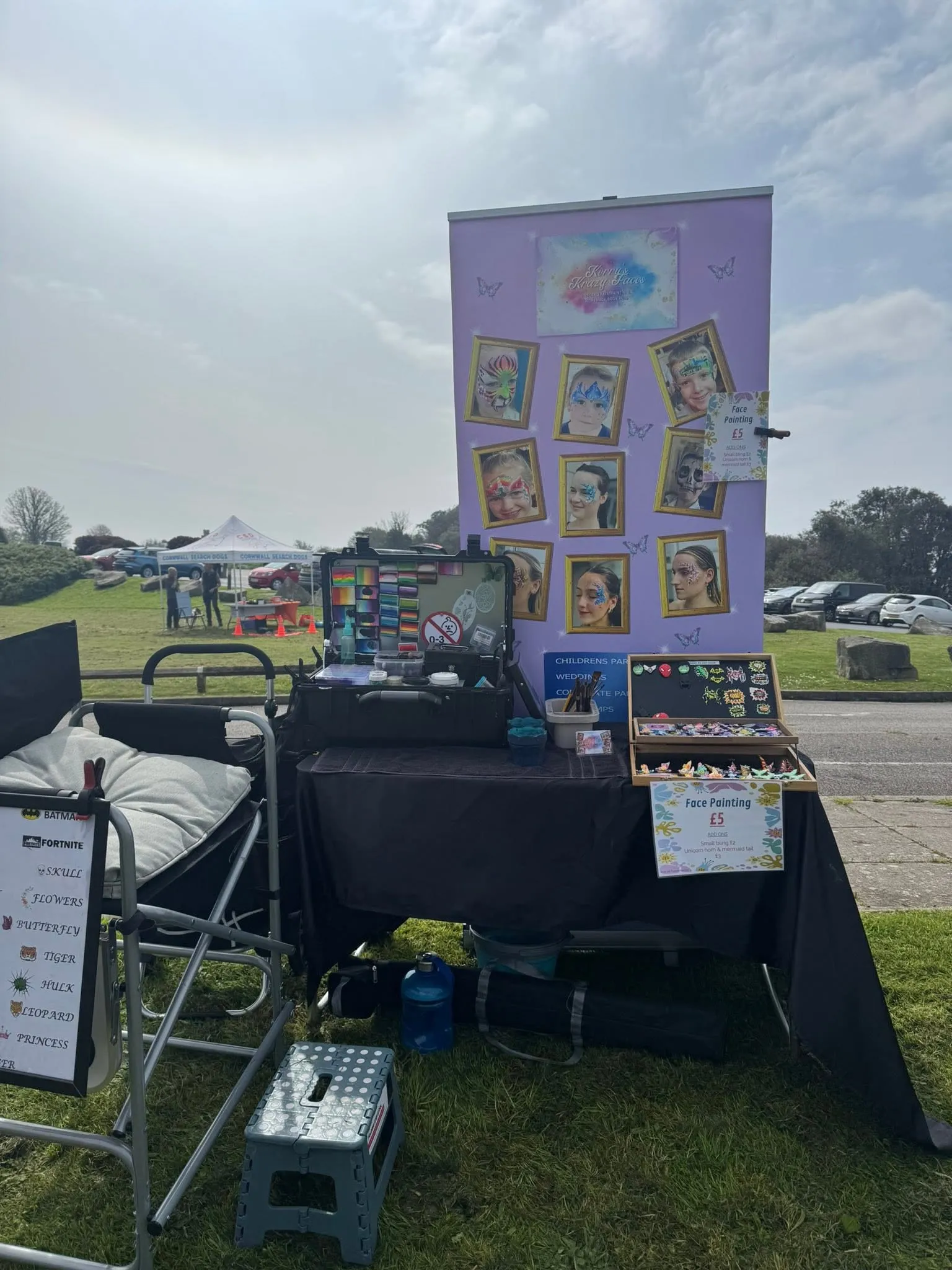 Kerry's face painting kit, banner and handmade bling set up at an outdoor event
