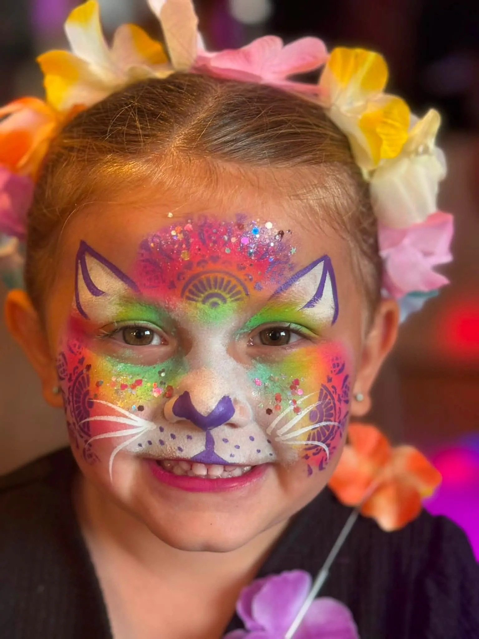 Girl with a rainbow cat face and flower crown