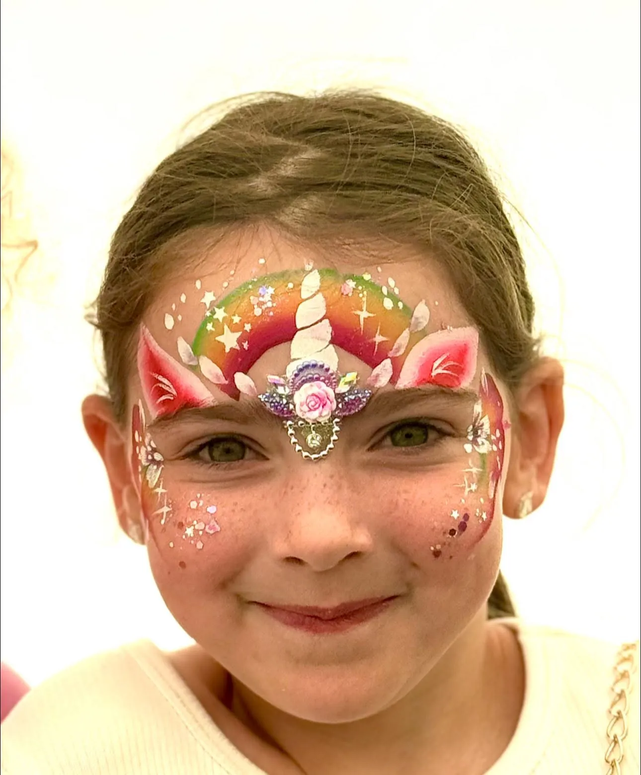 Girl with a unicorn crown and rainbow