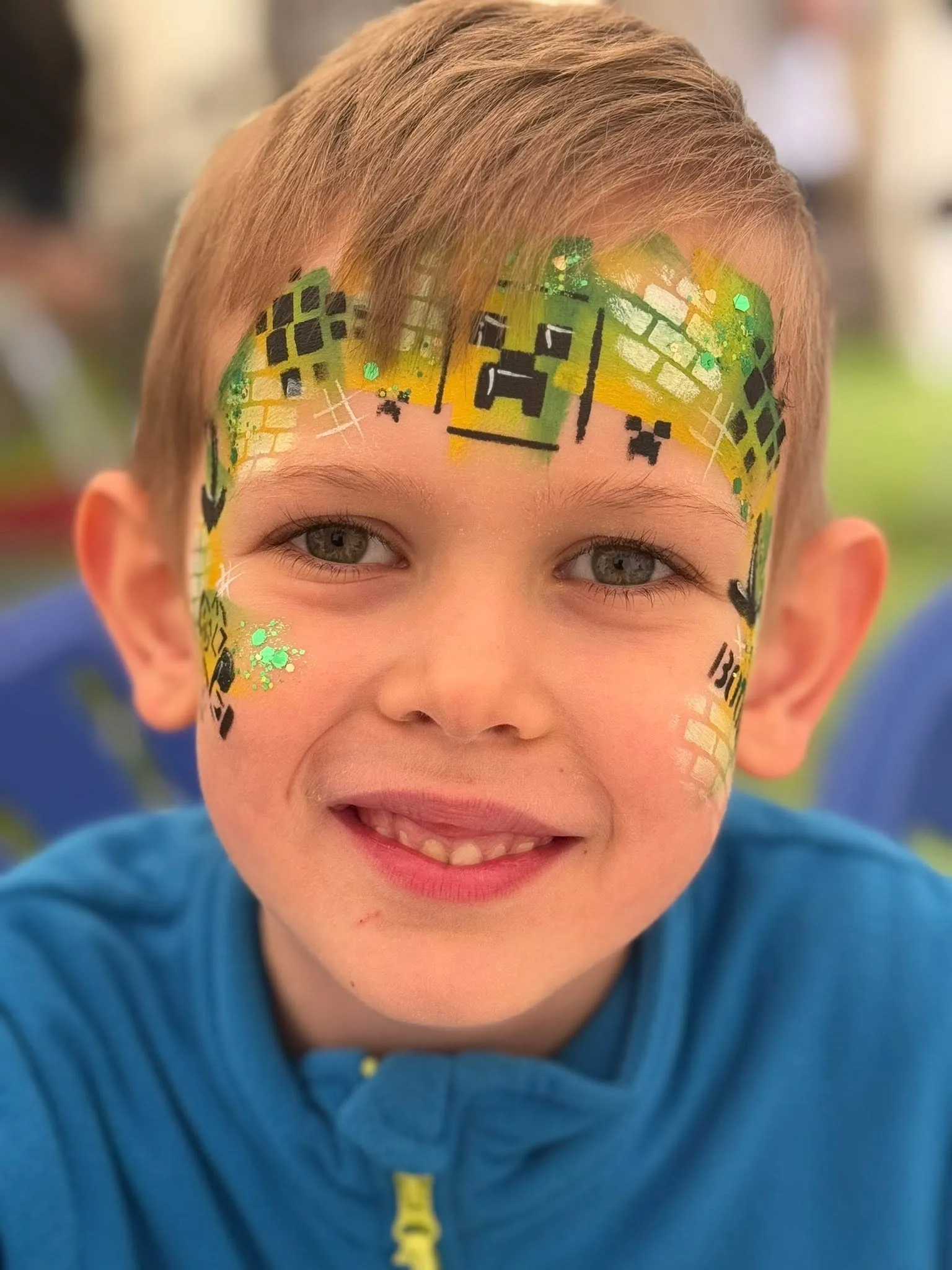 Boy with a green and yellow game character mask
